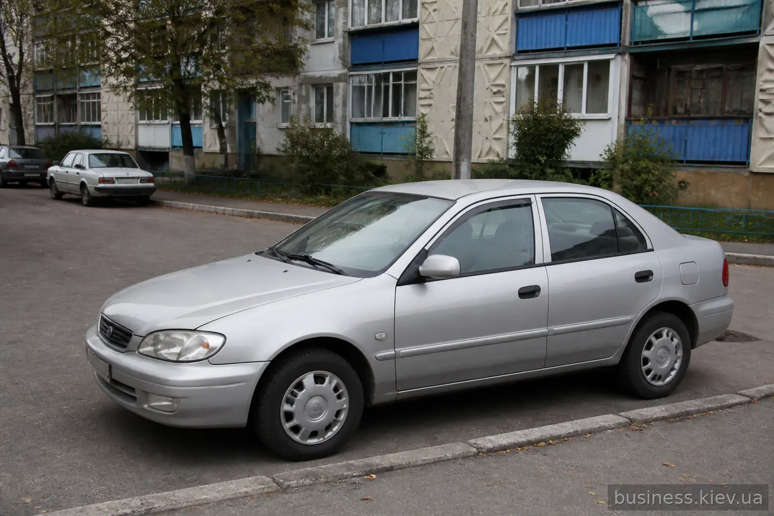 Компактний міський седан класу Toyota Corolla на житловій вулиці